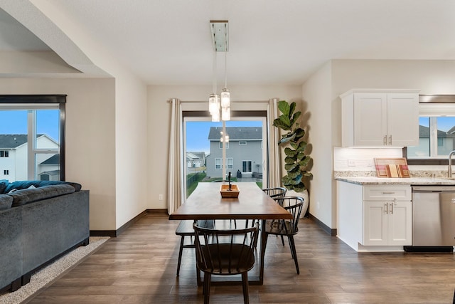 dining area featuring plenty of natural light and dark hardwood / wood-style flooring