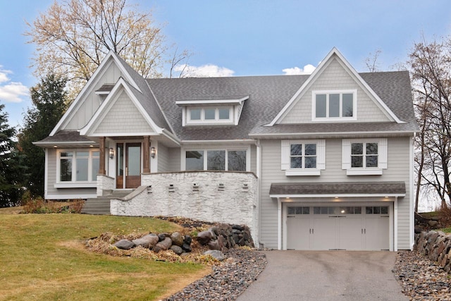 craftsman-style house with a garage and a front yard