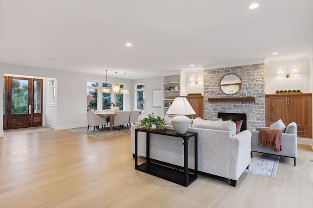 living room featuring a fireplace and light hardwood / wood-style flooring