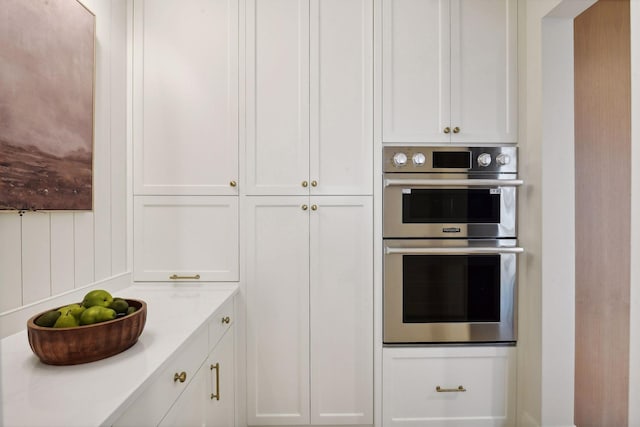 kitchen featuring stainless steel double oven and white cabinets