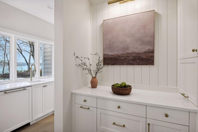 details with dishwasher, hardwood / wood-style floors, and sink