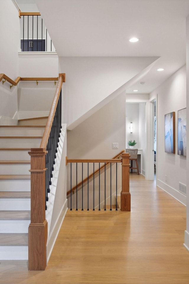 stairway with wood-type flooring