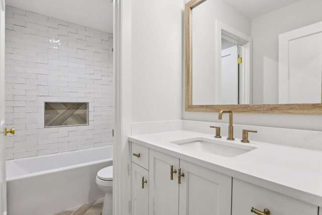 full bathroom with toilet, tiled shower / bath combo, and vanity