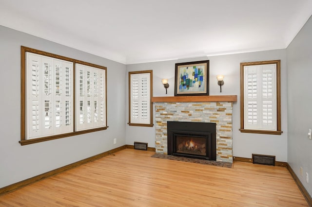 unfurnished living room with a fireplace and light hardwood / wood-style flooring