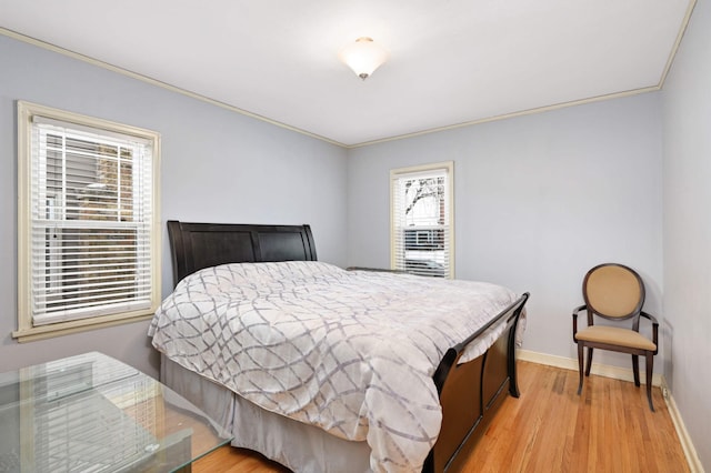 bedroom featuring light hardwood / wood-style flooring and ornamental molding