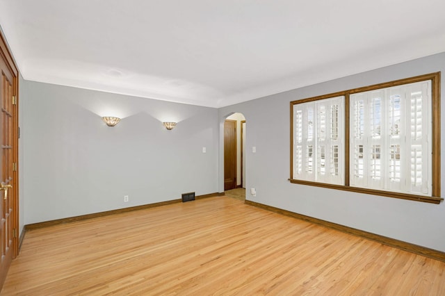 empty room with light hardwood / wood-style flooring