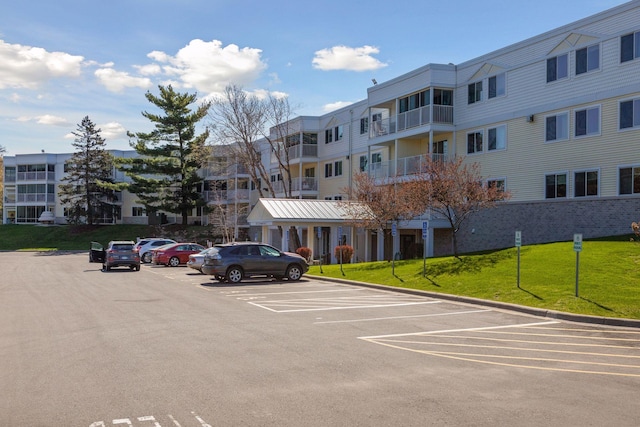 view of parking / parking lot with a lawn