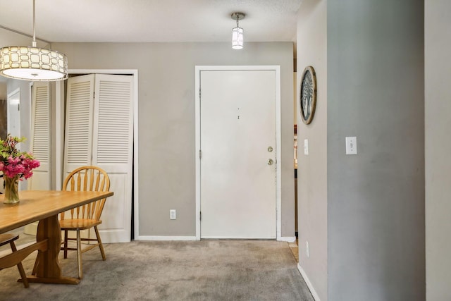 entrance foyer featuring carpet and a textured ceiling