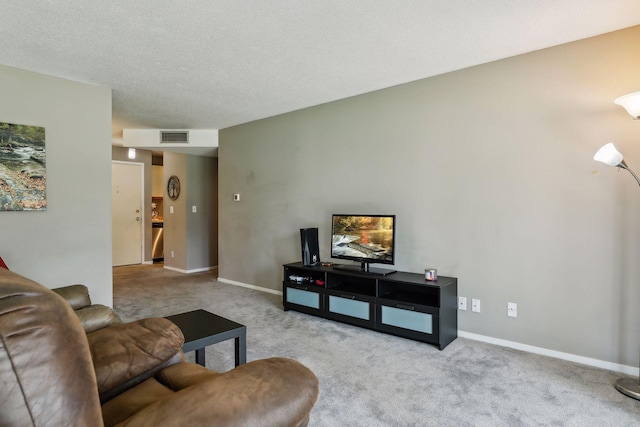 living room featuring light carpet and a textured ceiling