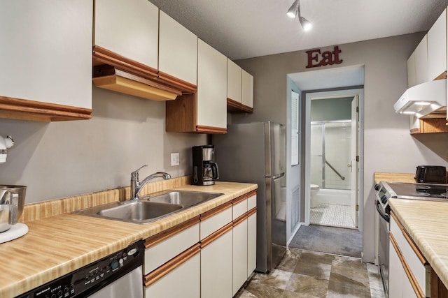 kitchen featuring white cabinets, stainless steel appliances, ventilation hood, and sink