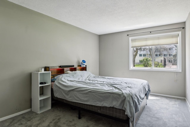 bedroom featuring a textured ceiling and carpet flooring