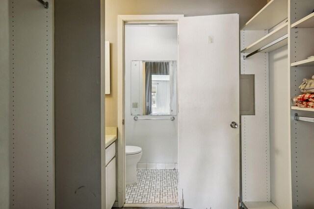 bathroom with vanity, toilet, and tile patterned flooring