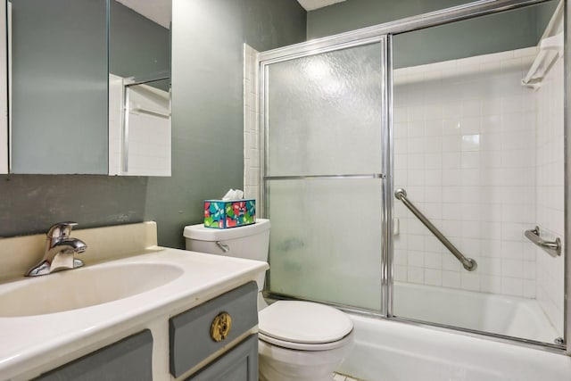 full bathroom with vanity, toilet, and shower / bath combination with glass door