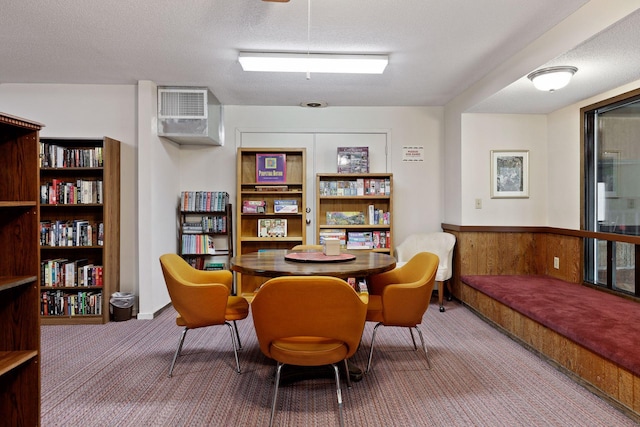 sitting room featuring carpet and a textured ceiling