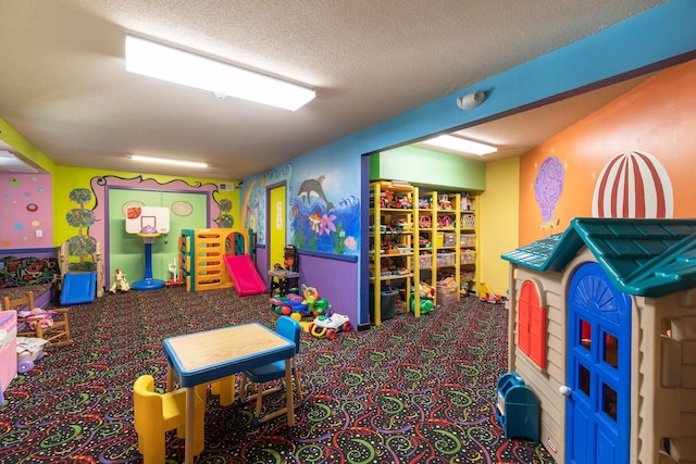 game room with a textured ceiling and carpet