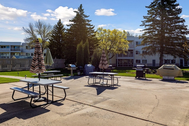 surrounding community with a patio and a lawn