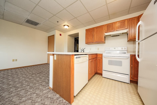 kitchen featuring kitchen peninsula, a paneled ceiling, white appliances, and light colored carpet