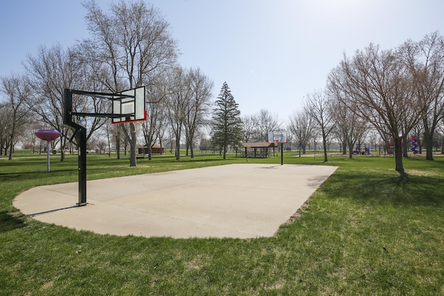 view of basketball court with a lawn