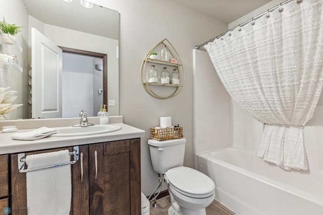 full bathroom with hardwood / wood-style flooring, vanity, toilet, and shower / tub combo