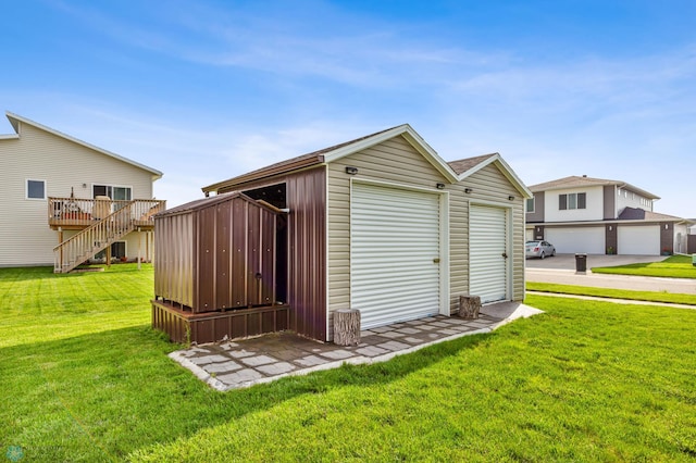 view of outbuilding featuring a garage and a yard