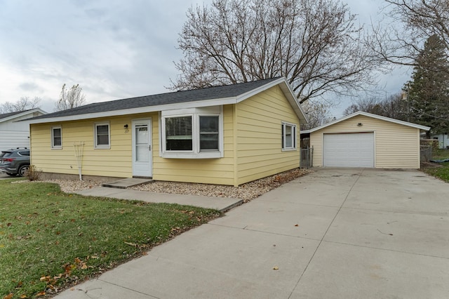 ranch-style home with an outbuilding, a front lawn, and a garage