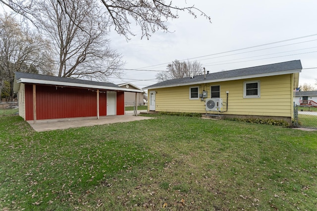 back of house with a patio area and a lawn