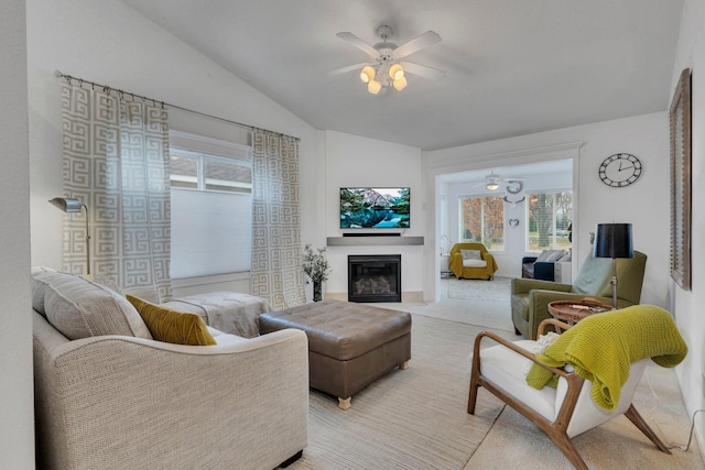 living room with vaulted ceiling, light colored carpet, and ceiling fan