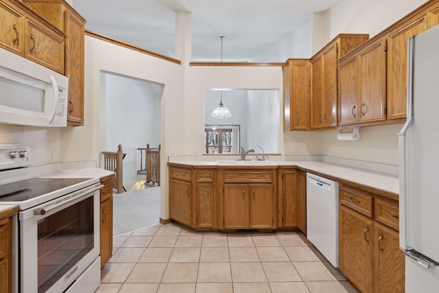 kitchen with white appliances, light tile patterned floors, pendant lighting, and sink