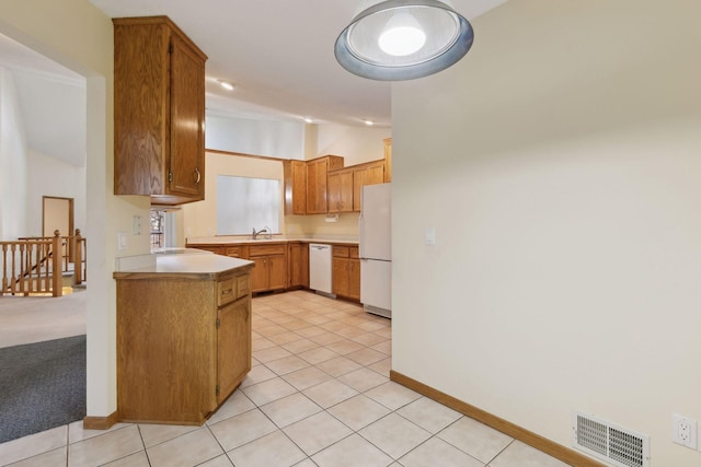 kitchen with vaulted ceiling, white appliances, light tile patterned floors, and kitchen peninsula