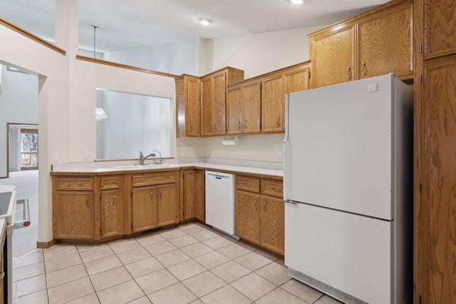 kitchen featuring white appliances, light tile patterned flooring, vaulted ceiling, and sink