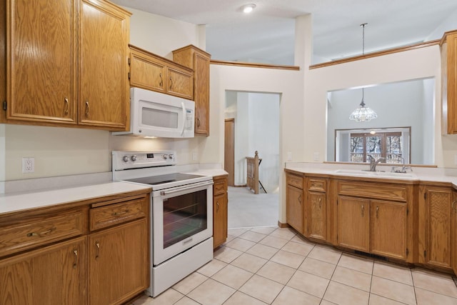 kitchen featuring white appliances, a chandelier, pendant lighting, light tile patterned floors, and sink