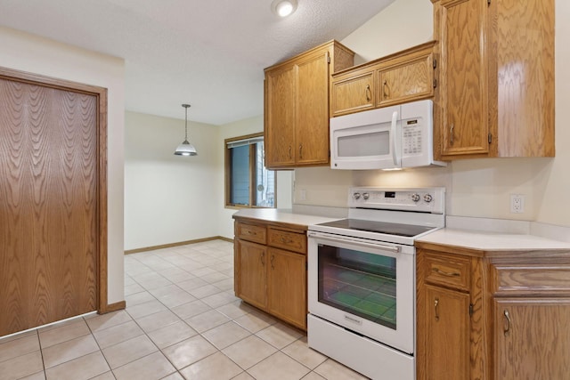 kitchen featuring white appliances, a textured ceiling, light tile patterned floors, and hanging light fixtures