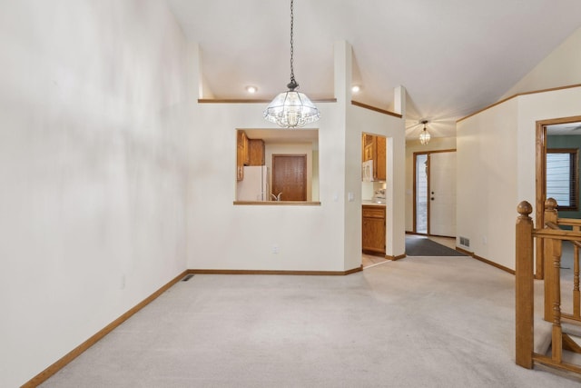 unfurnished living room featuring a notable chandelier and light colored carpet