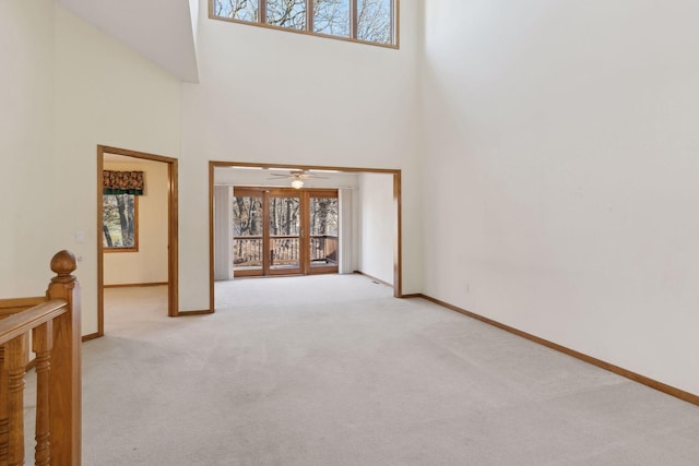 interior space with a high ceiling and ceiling fan