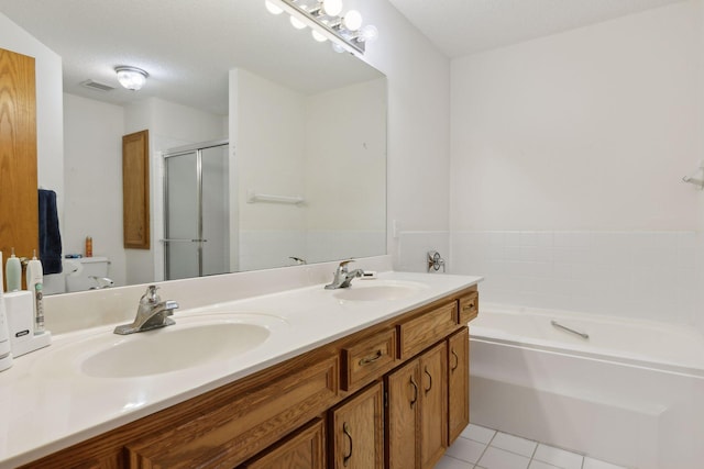 bathroom with vanity, tile patterned flooring, a textured ceiling, and separate shower and tub