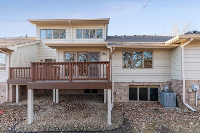 back of property featuring a deck and cooling unit