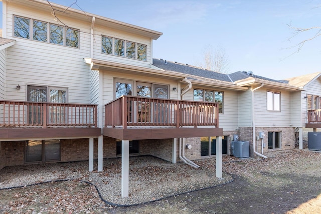 back of house featuring cooling unit and a wooden deck