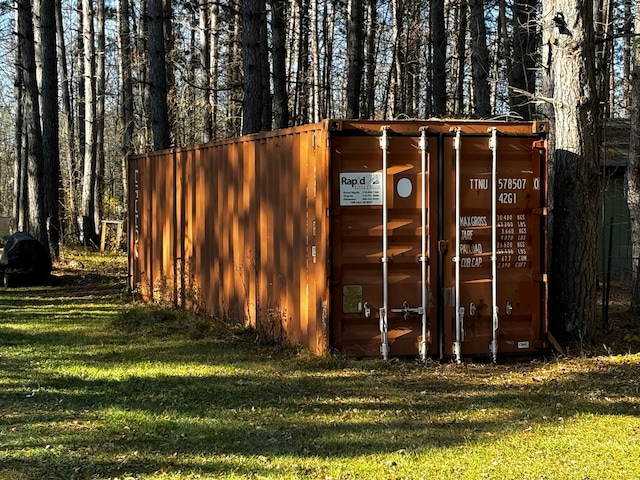 view of outdoor structure featuring a lawn