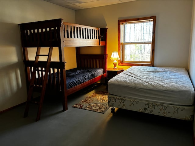 bedroom featuring a paneled ceiling and carpet flooring