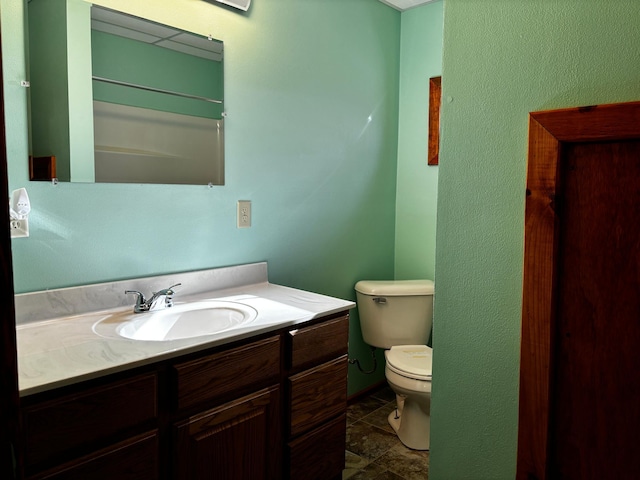 bathroom featuring toilet and vanity