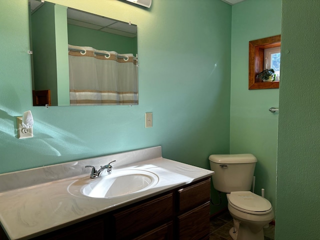 bathroom with vanity, a shower with shower curtain, toilet, and tile patterned floors