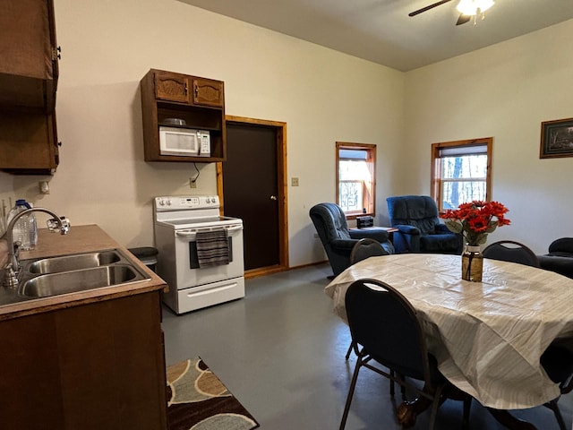 dining room with ceiling fan and sink