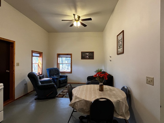 dining room with ceiling fan and concrete flooring