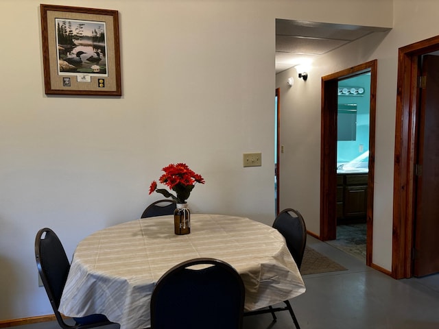 dining area with concrete flooring