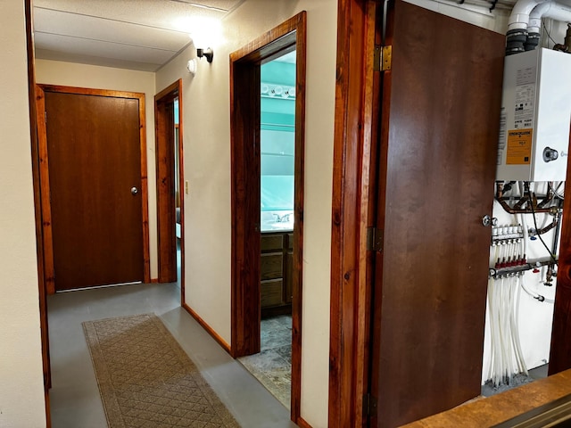 hallway with sink and water heater