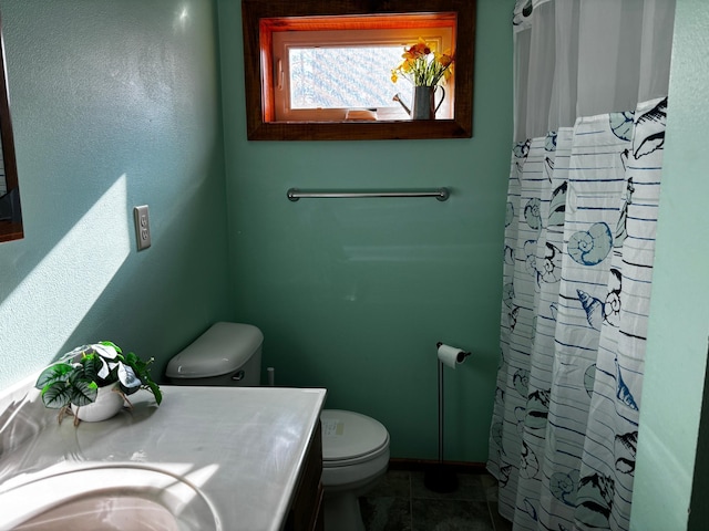 bathroom featuring toilet, vanity, a shower with shower curtain, and tile patterned flooring