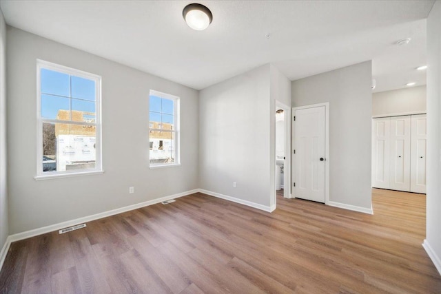 unfurnished room featuring wood-type flooring