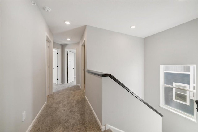 hall featuring light colored carpet