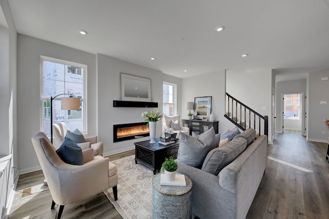 living room with hardwood / wood-style flooring and a healthy amount of sunlight