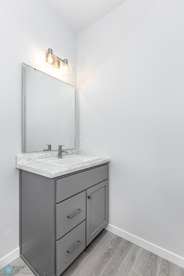 bathroom featuring vanity and hardwood / wood-style flooring